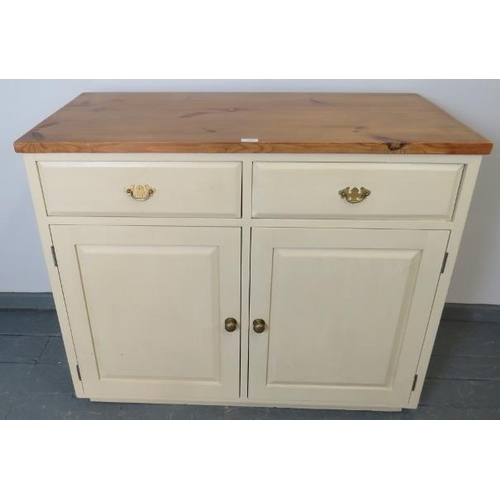 768 - A pine sideboard painted cream with stripped top, housing two short drawers over two cupboards, all ... 