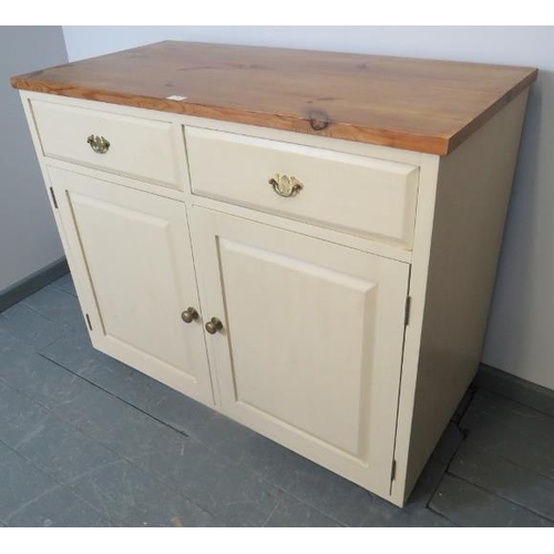 768 - A pine sideboard painted cream with stripped top, housing two short drawers over two cupboards, all ... 