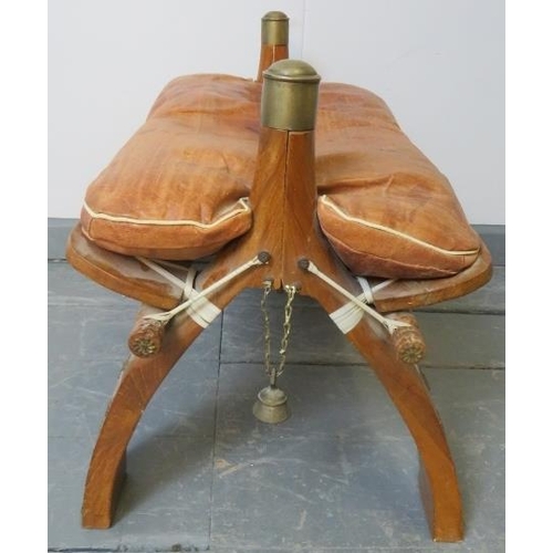 773 - A vintage camel stool with loose seat cushion upholstered in tan leather.
Condition report: Minor ma... 