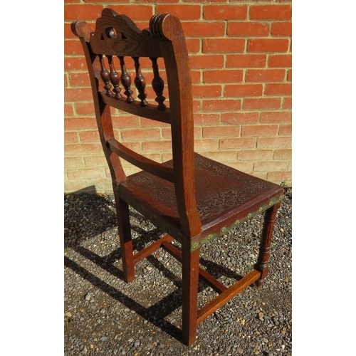 775 - Five Edwardian oak dining chairs with embossed leather seats, on reeded supports with stretchers, an... 