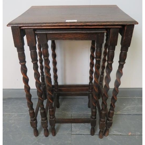 801 - An early 20th century nest of three oak tables, on barley twist supports with stretchers.
Condition ... 