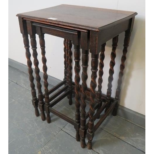 801 - An early 20th century nest of three oak tables, on barley twist supports with stretchers.
Condition ... 