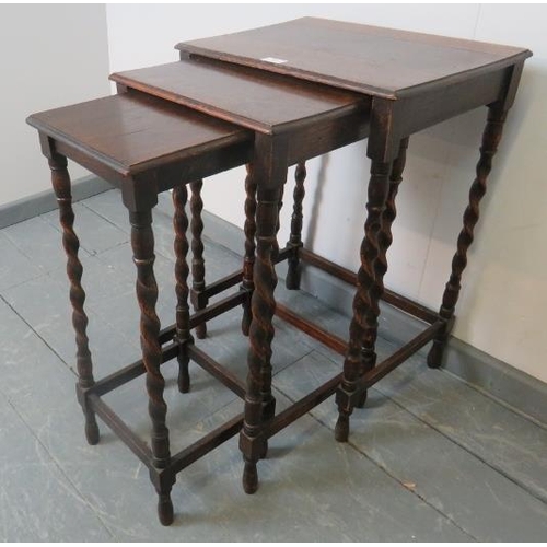 801 - An early 20th century nest of three oak tables, on barley twist supports with stretchers.
Condition ... 