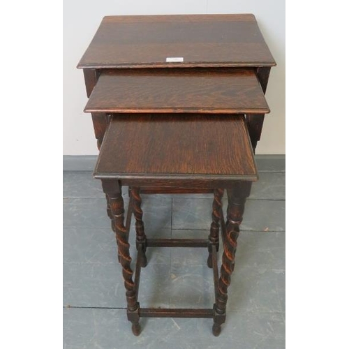 801 - An early 20th century nest of three oak tables, on barley twist supports with stretchers.
Condition ... 