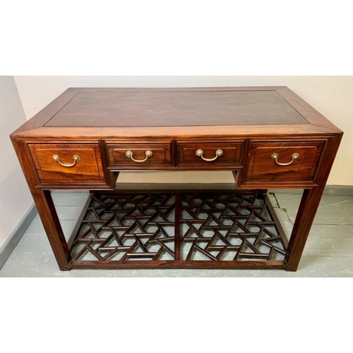 714 - A Chinese period style tropical hardwood desk, housing four short drawers with brass handles, raised... 