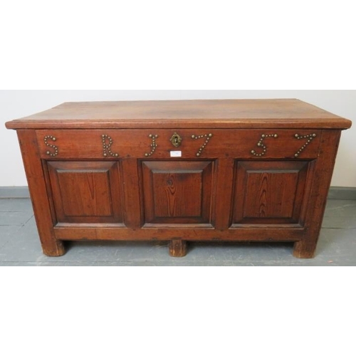 713 - An 18th century medium oak coffer with internal candle box, fielded panels to front and applied bras... 