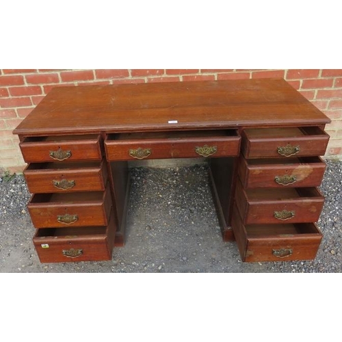 716 - An Edwardian mahogany kneehole desk, housing a configuration of nine graduated drawer, with fancy br... 