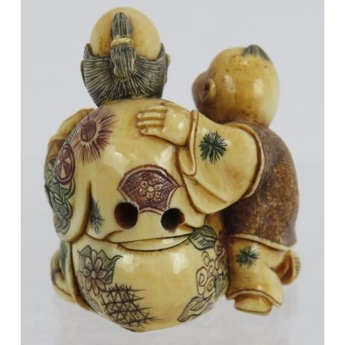 12 - A very finely carved Japanese ivory Netsuke, Meiji period of a man with child holding a fan decorate... 