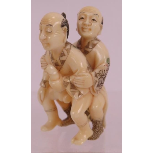 17 - A finely carved erotic Japanese ivory Netsuke, early 20th century, featuring two men and decorated i... 