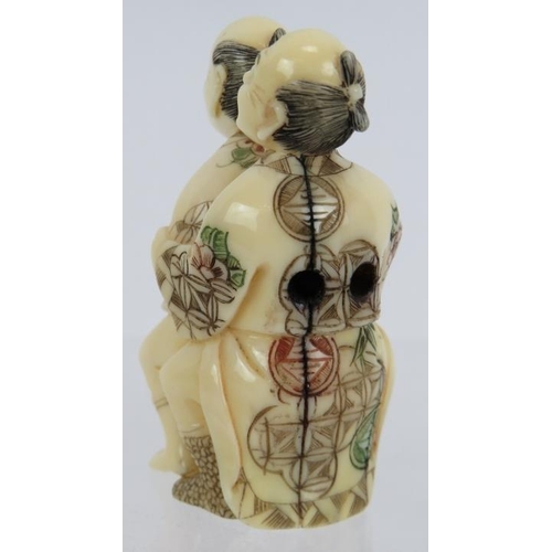 17 - A finely carved erotic Japanese ivory Netsuke, early 20th century, featuring two men and decorated i... 