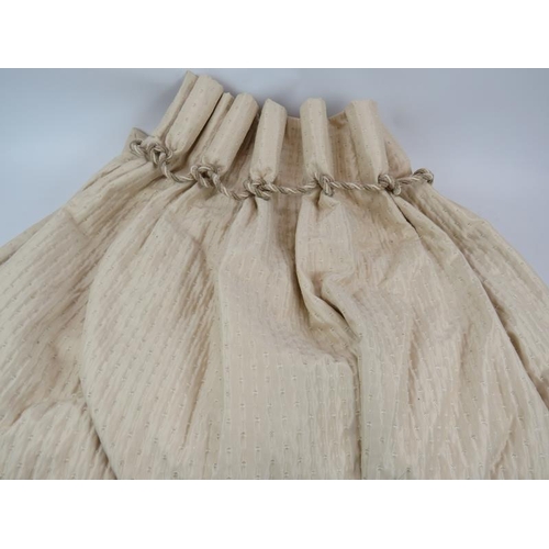 220 - Two pairs of ivory ruched silk curtains with rope twist pleated headers, fully lined. Each curtain d... 