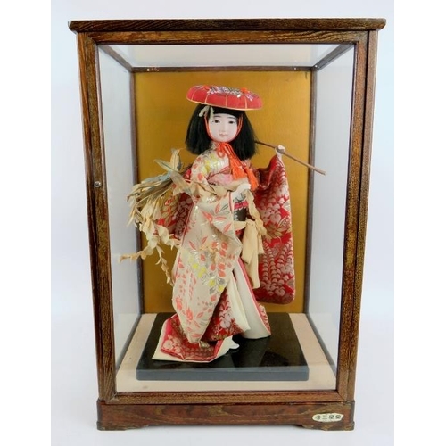 226 - A fashion model of a Japanese Geisha in silk robes displayed in a glazed wooden case.  Overall size:... 