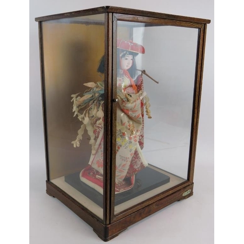 226 - A fashion model of a Japanese Geisha in silk robes displayed in a glazed wooden case.  Overall size:... 