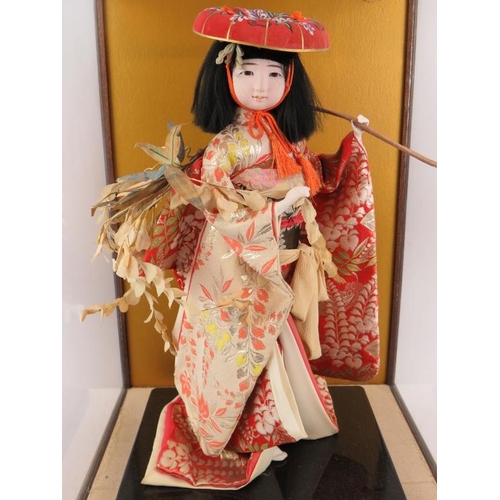 226 - A fashion model of a Japanese Geisha in silk robes displayed in a glazed wooden case.  Overall size:... 