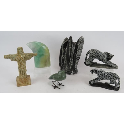 235 - A carved fossil sculpture, two carved stone leopards, a green quartz claw, a green stone bird and a ... 