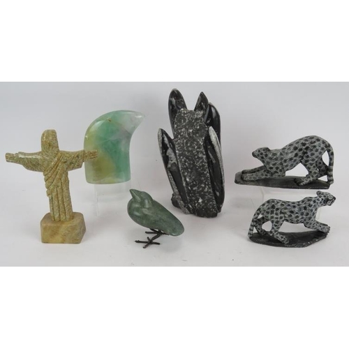 235 - A carved fossil sculpture, two carved stone leopards, a green quartz claw, a green stone bird and a ... 