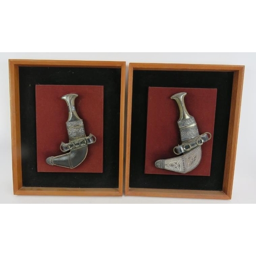 237 - Two framed and mounted Omani Khanjar daggers with white metal decoration and two eastern Dallah coff... 