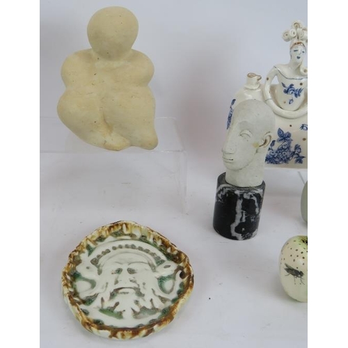 240 - Nine pieces of studio pottery including four abstract figures, a green man pin dish and an Egyptian ... 