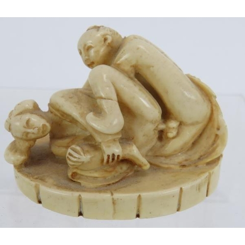 29 - A Japanese carved ivory erotic Okimono, early 20th century, featuring a man and woman in erotic pose... 