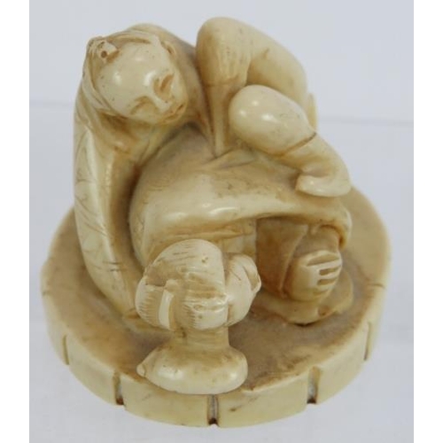 29 - A Japanese carved ivory erotic Okimono, early 20th century, featuring a man and woman in erotic pose... 