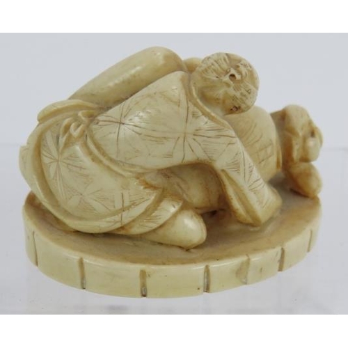 29 - A Japanese carved ivory erotic Okimono, early 20th century, featuring a man and woman in erotic pose... 