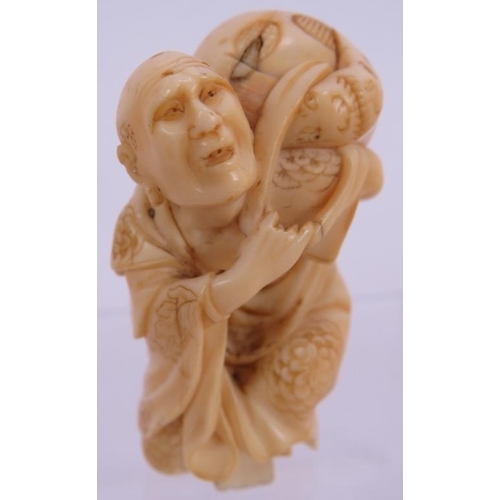 43 - A well carved Japanese Meiji period ivory Netsuke of a man carrying a gourd, signed to foot. Height ... 