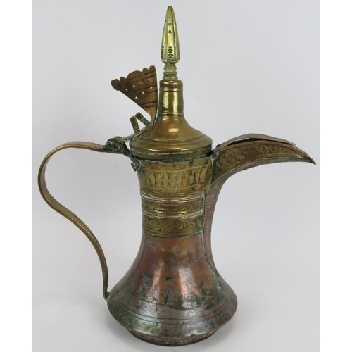 47 - A large antique middle Eastern Dallah coffee pot of copper and brass construction. Height 44cm. 
Con... 