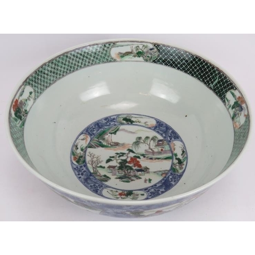 48 - A large Chinese porcelain bowl decorated in the Famille Verte style with enamelled panels depicting ... 