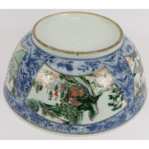 48 - A large Chinese porcelain bowl decorated in the Famille Verte style with enamelled panels depicting ... 