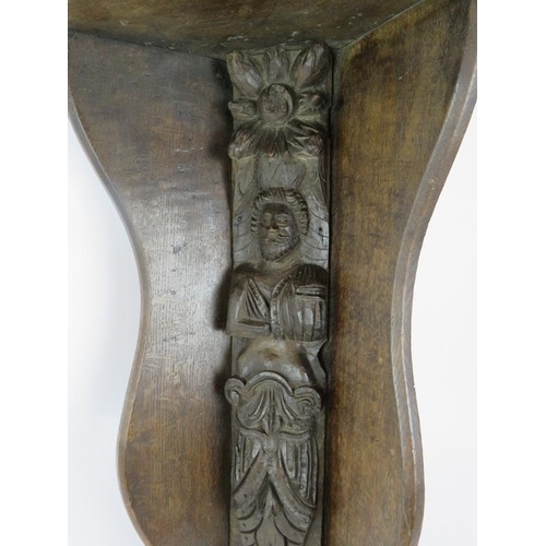 53 - A large oak wall bracket corner shelf with earlier carved caryatid figure to centre. Height 62cm.
Co... 