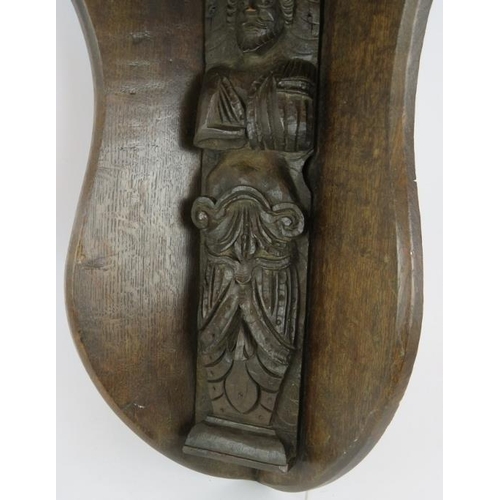 53 - A large oak wall bracket corner shelf with earlier carved caryatid figure to centre. Height 62cm.
Co... 