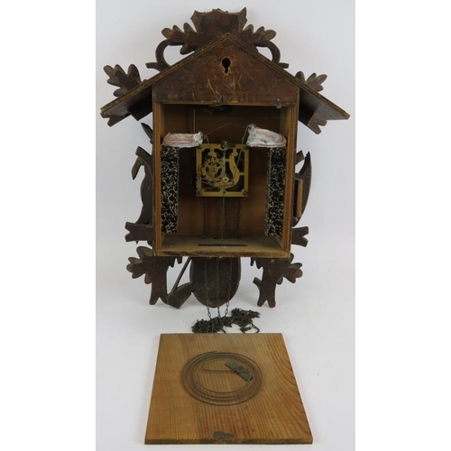 54 - A large Black Forest style cuckoo clock with carved hunting themed animals. Height 60cm.
Condition r... 