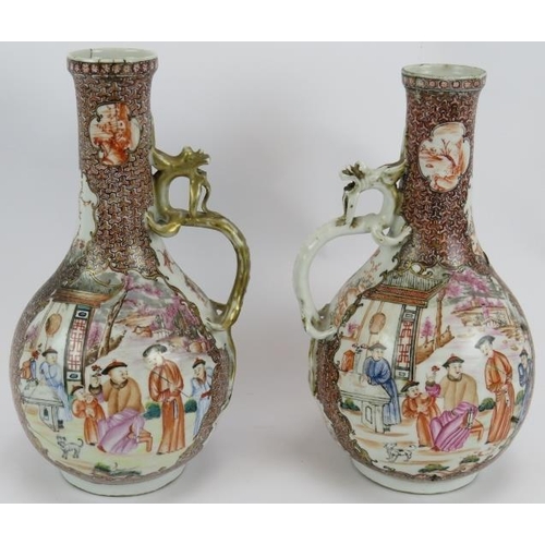 59 - A pair of antique Chinese porcelain ewers with ornate decoration and applied dragon handles. Collect... 