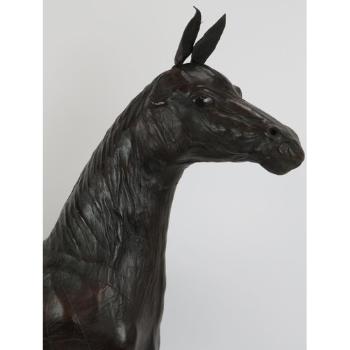 62 - A large vintage leather horse with glass eyes, possibly by Liberty & Co. Height 71cm.
Condition repo... 