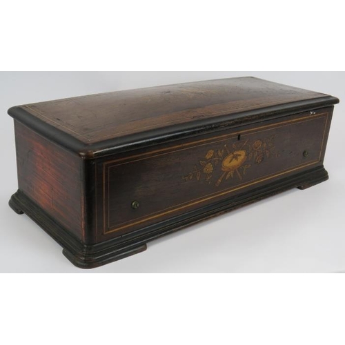 63 - A large 19th century music box in an inlaid mahogany case, probably Swiss. Length 57cm. Depth 24cm. ... 