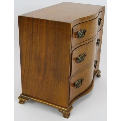 69 - A good quality miniature serpentine fronted chest of drawers, circa 1920s stamped 'H. Uphill Wilton'... 