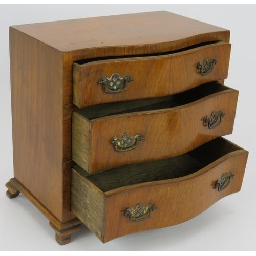 69 - A good quality miniature serpentine fronted chest of drawers, circa 1920s stamped 'H. Uphill Wilton'... 