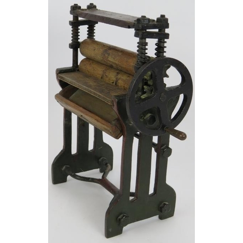 72 - A miniature laundry mangle constructed from steel, brass and wood, fully working. Height 26cm.
Condi... 