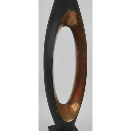 78 - A modernistic copper table lamp of elongated form mounted on a black marble base. Height 63cm.
Condi... 