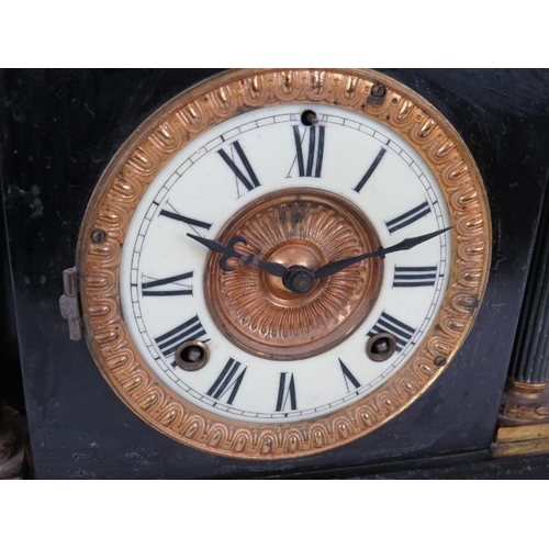 81 - An antique American striking mantel clock with blackened steel case and Ansonia movement. Key and pe... 