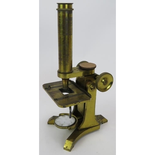 84 - A mid 19th century brass microscope by Moritz Pillischer London No 584, with spare lenses and mahoga... 