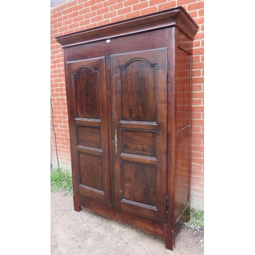 703 - An 18th century French cherrywood armoire of excellent colour with fielded panels to doors, brass lo... 