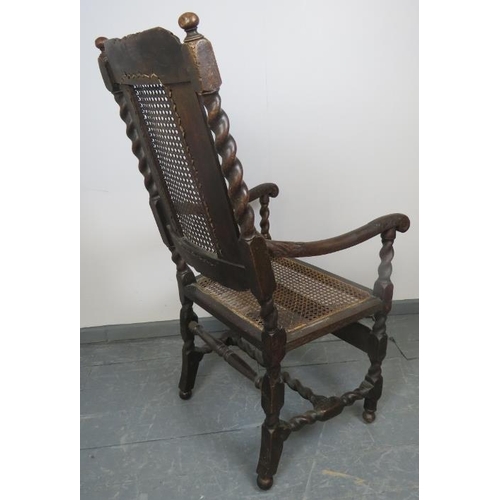 704 - A 17th century Carolean oak hall chair with bergere back and seat panels, featuring barley twist upr... 