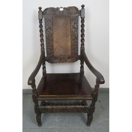 704 - A 17th century Carolean oak hall chair with bergere back and seat panels, featuring barley twist upr... 