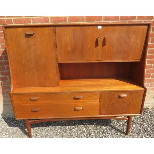 710 - A mid-century teak highboard by G Plan, featuring a fall front drinks cabinet, two cupboards and two... 