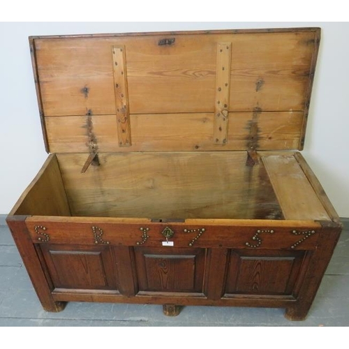 713 - An 18th century medium oak coffer with internal candle box, fielded panels to front and applied bras... 