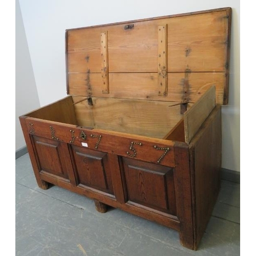 713 - An 18th century medium oak coffer with internal candle box, fielded panels to front and applied bras... 