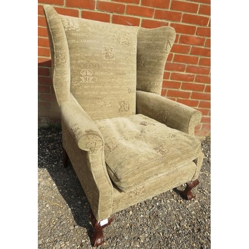 714 - A Georgian style wingback armchair upholstered in a contemporary material featuring Latin text, on b... 