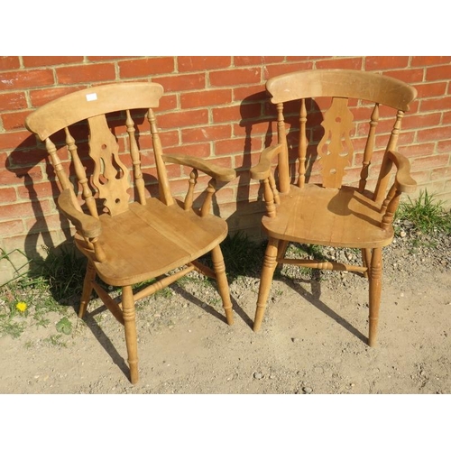 715 - A pair of 19th century style light fruitwood Windsor open sided armchairs, on turned supports with a... 