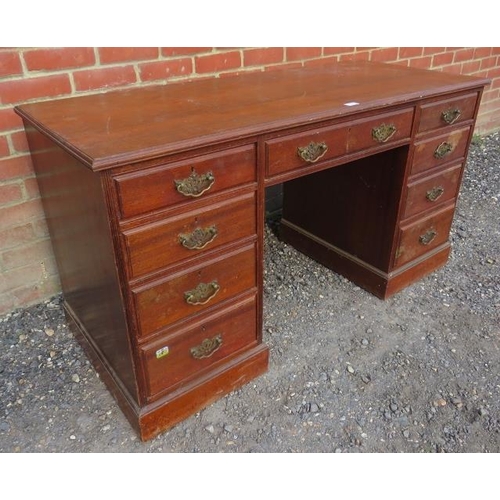 716 - An Edwardian mahogany kneehole desk, housing a configuration of nine graduated drawer, with fancy br... 